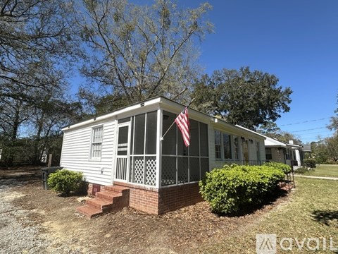 A small house with a flag on the front porch.