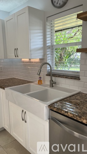 A kitchen with a sink and cabinets.