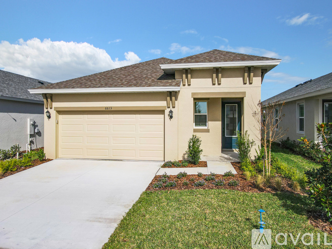 A house with a beige garage door is for sale.