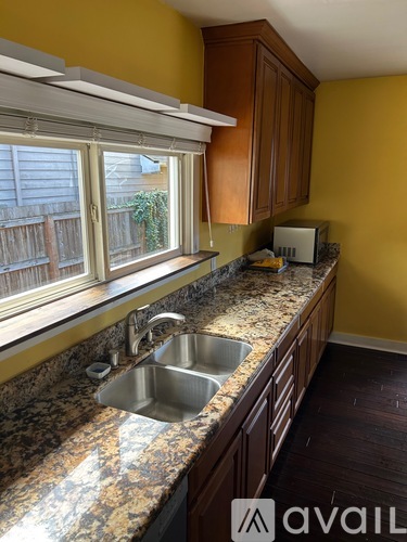 A kitchen with a sink and a window.
