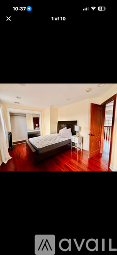 A bedroom with a bed, dresser, and mirror.