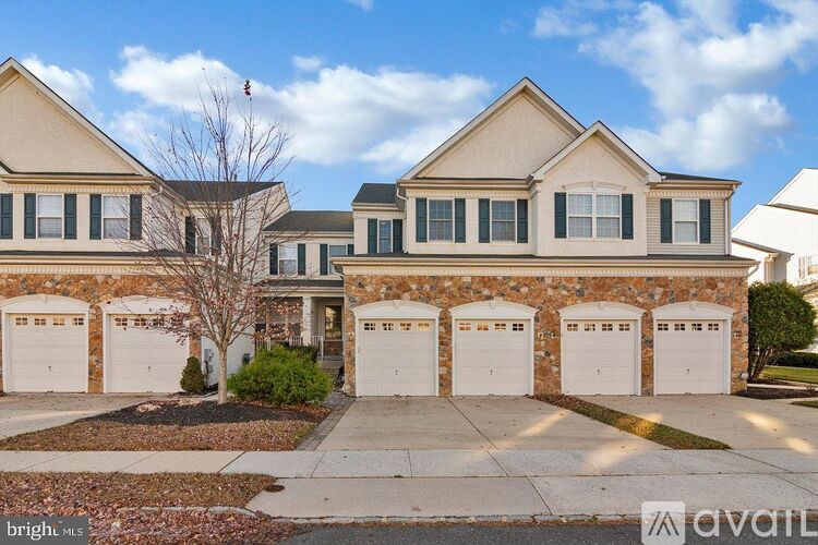 A row of garage doors in front of a house.