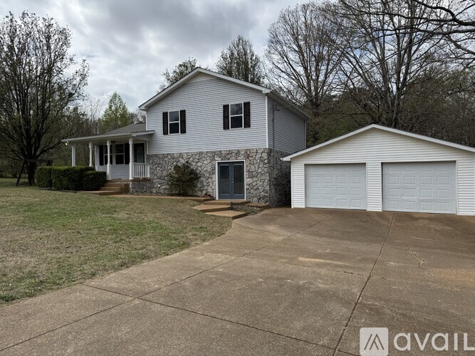 A house with a garage is available for sale.