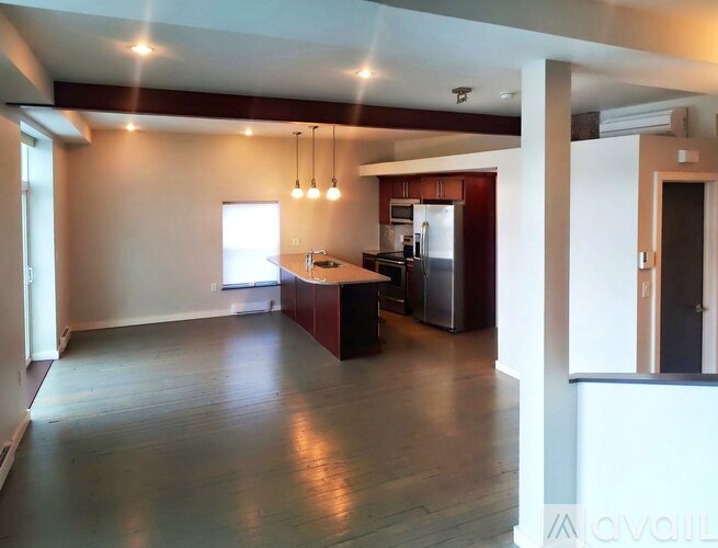 A kitchen with a refrigerator, sink, and stove is available for rent.
