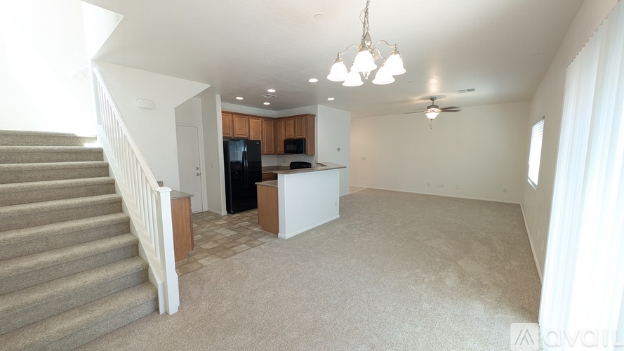 A living room with a staircase leading to the upper floor.