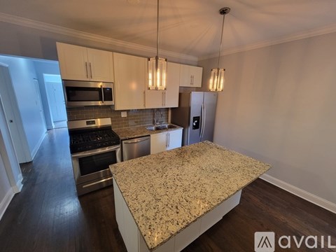 A kitchen with granite countertops and stainless steel appliances.