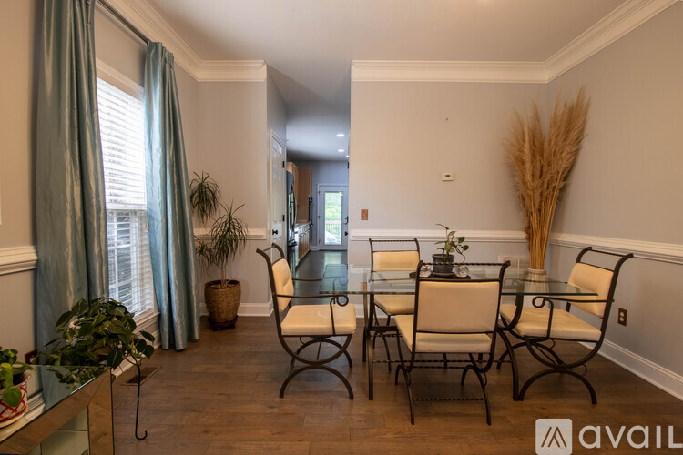A dining room with a glass table and chairs.