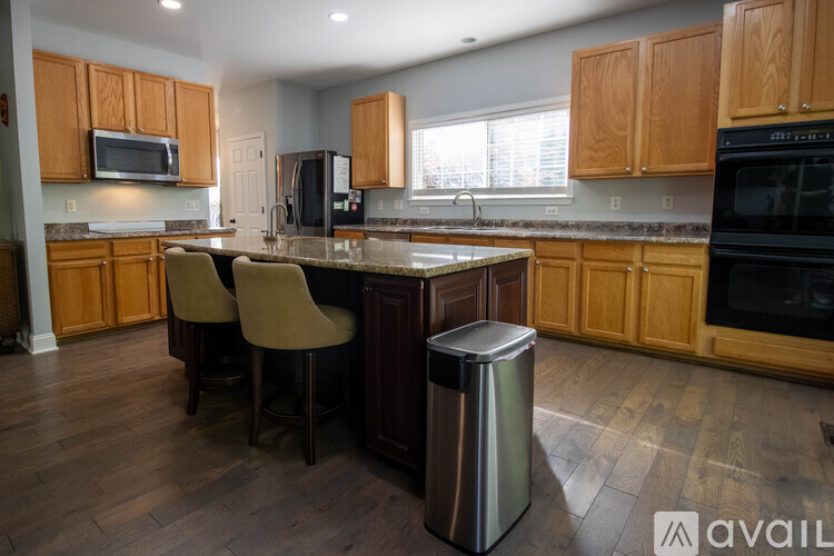 A kitchen with wooden cabinets and a granite countertop.