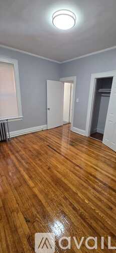A room with wooden floors and a white ceiling light.