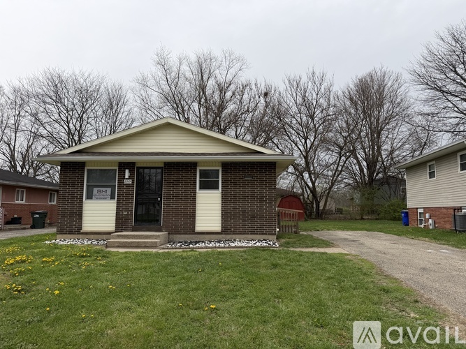 A house with a front yard and a sign that says "available".