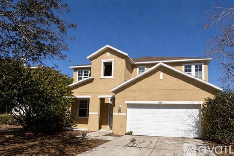 A two-story house with a garage is for sale.