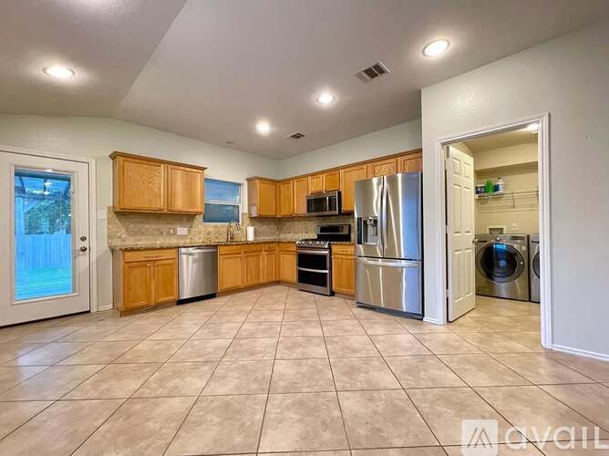 A kitchen with wooden cabinets and stainless steel appliances.