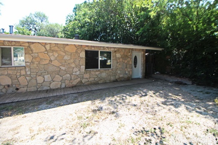 A stone house with a door and windows.