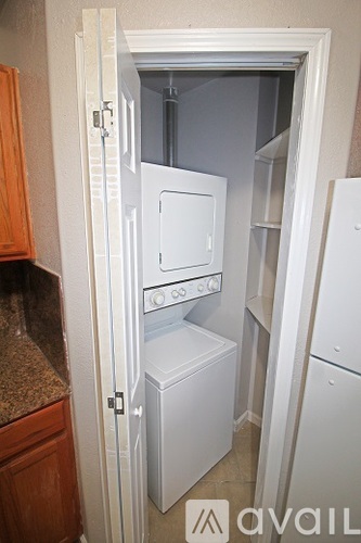 A small kitchen with a white oven and dishwasher.