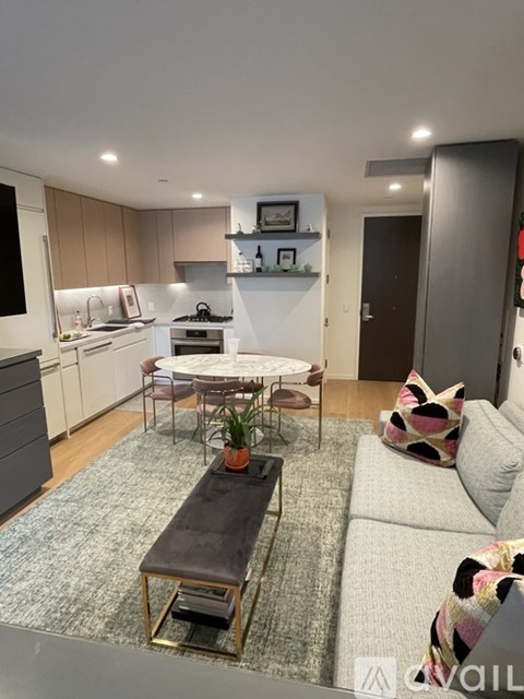 A modern living room with a grey couch and a coffee table.