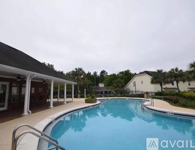 A pool with a white building in the background.