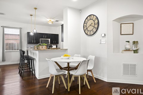 A kitchen with a table and chairs in the middle of the room.