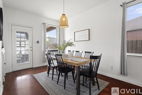 A dining room with a wooden table and chairs.