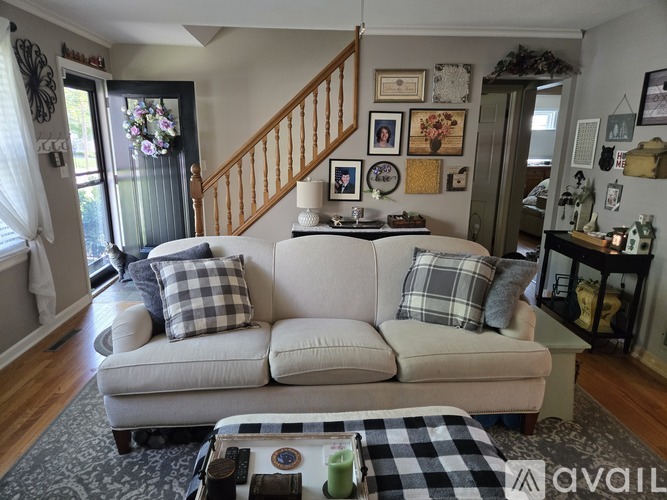 A living room with a couch, coffee table, and pictures on the wall.