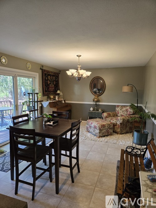 A dining room with a table and chairs.