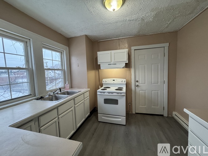 A small kitchen with a stove and sink.