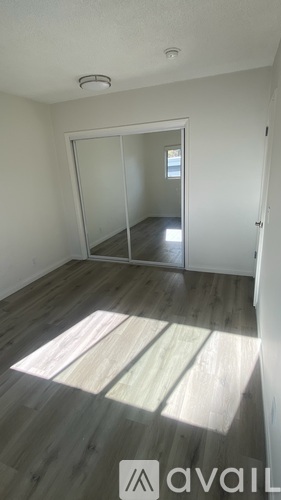 A room with a wooden floor and a white door.