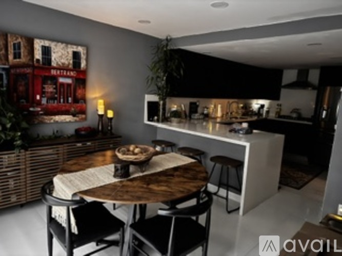 A modern kitchen with a dining table and chairs.