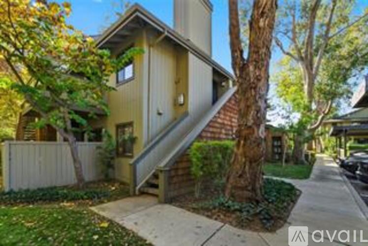 A house with a tree in front of it.