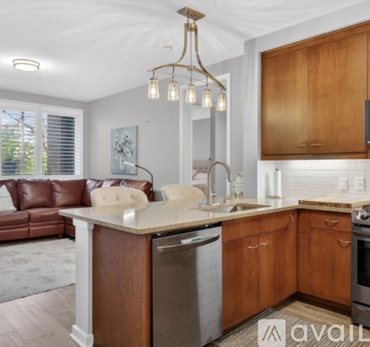 A kitchen with brown cabinets and a white countertop.