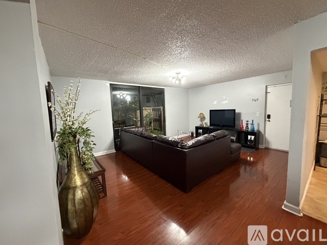 A living room with a brown sofa and a television.
