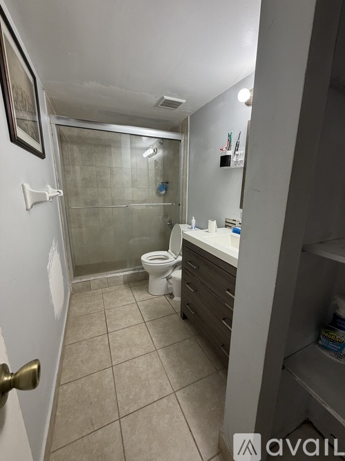 A bathroom with a toilet, sink, and shower.