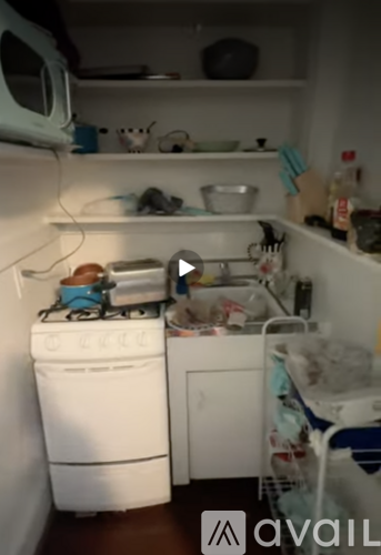 A small, cluttered laundry room with a washer and dryer.