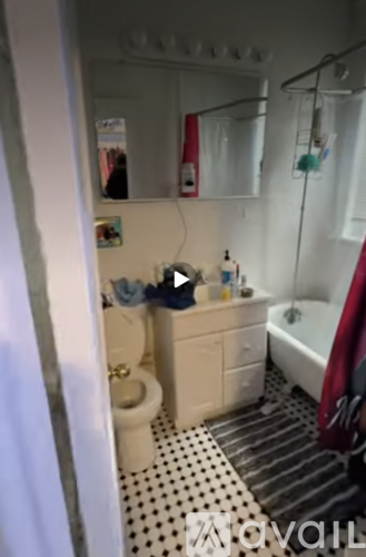 A bathroom with a toilet, sink, and shower.