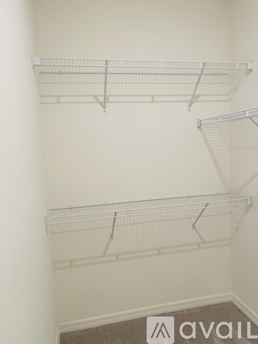 Empty white shelves in a room.