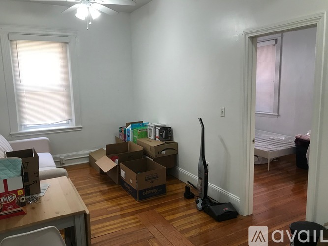 A room with boxes and a vacuum cleaner on the floor.