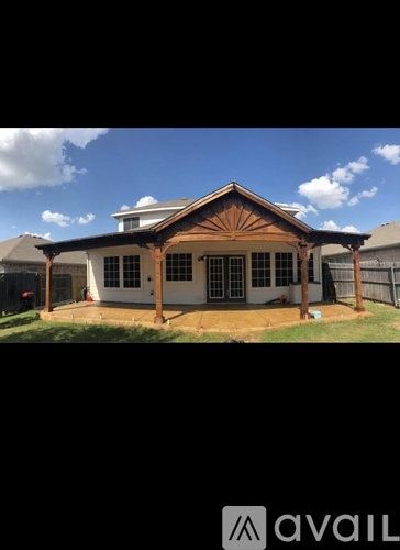 A house with a brown roof and white walls is available for sale.
