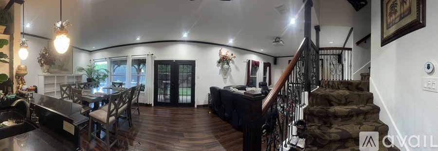 A large open space with a staircase leading to the upper floor.