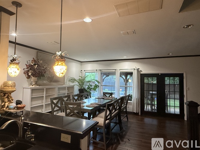 A modern kitchen with a dining table and chairs.