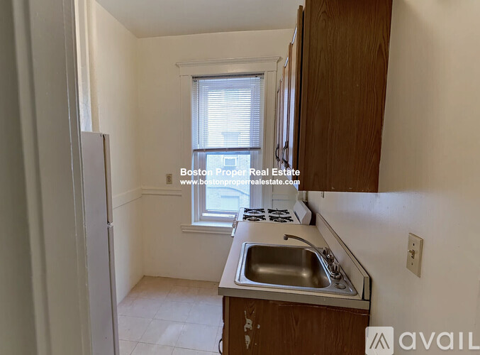A kitchen with a sink and a window.