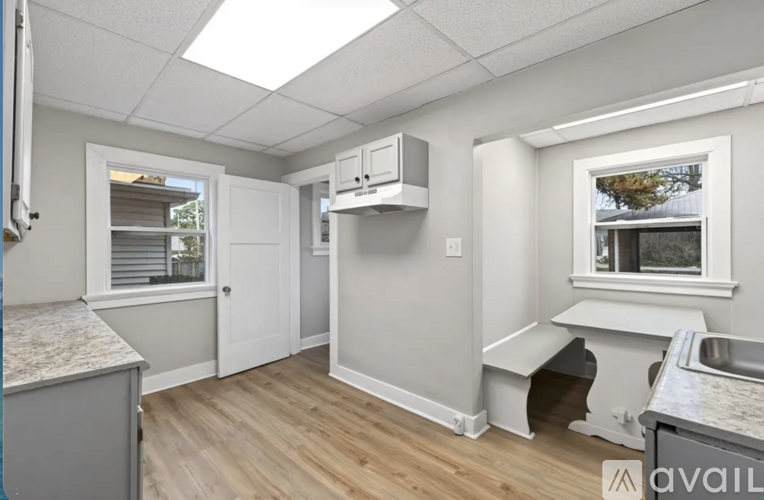 A kitchen area with a window and a bench.