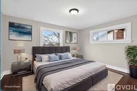 A bedroom with a large bed and a painting on the wall.