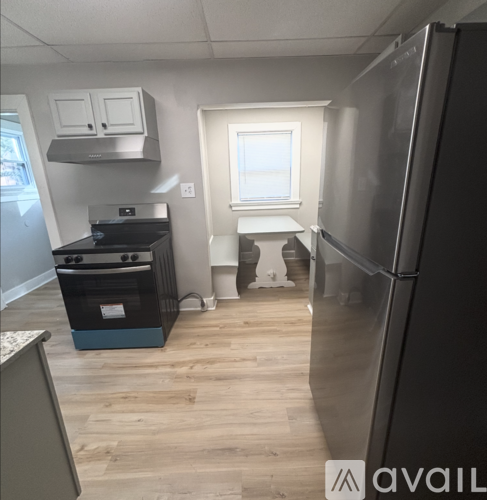 A kitchen with a stove, oven, and refrigerator.