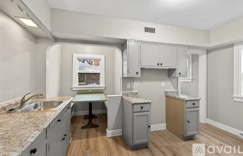 A kitchen with a granite countertop and a window.