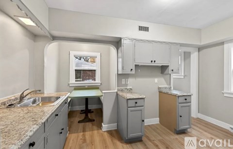 A kitchen with a granite countertop and a window.