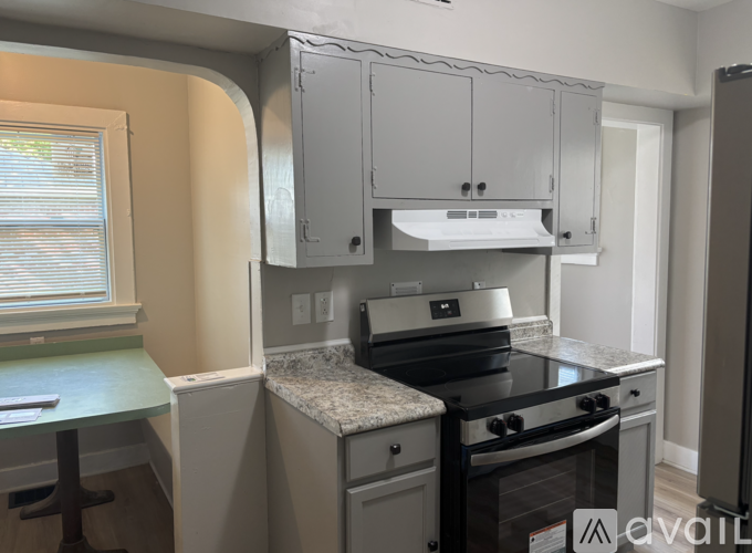 A kitchen with a stove top oven and a counter top.