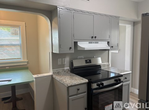 A kitchen with a stove top oven and a counter top.