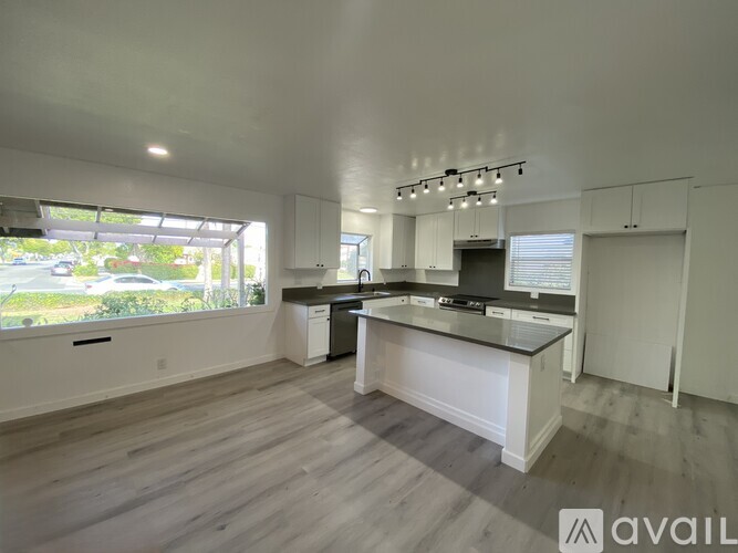 A spacious kitchen with a large island in the middle.