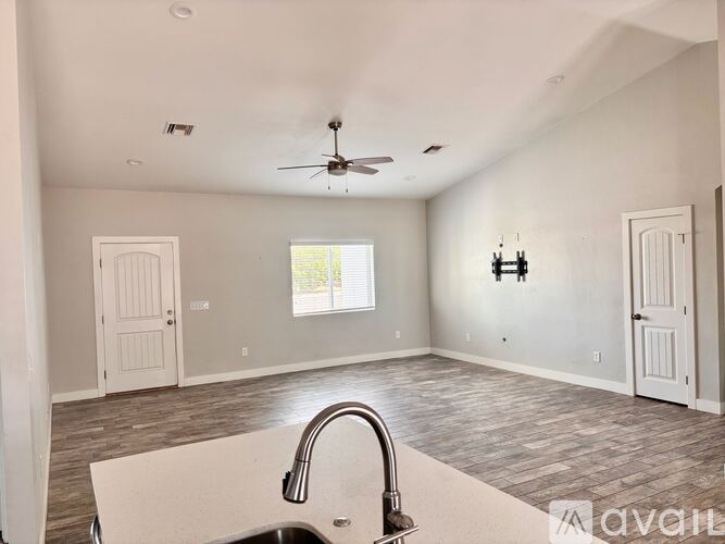 A kitchen with a sink and a window.