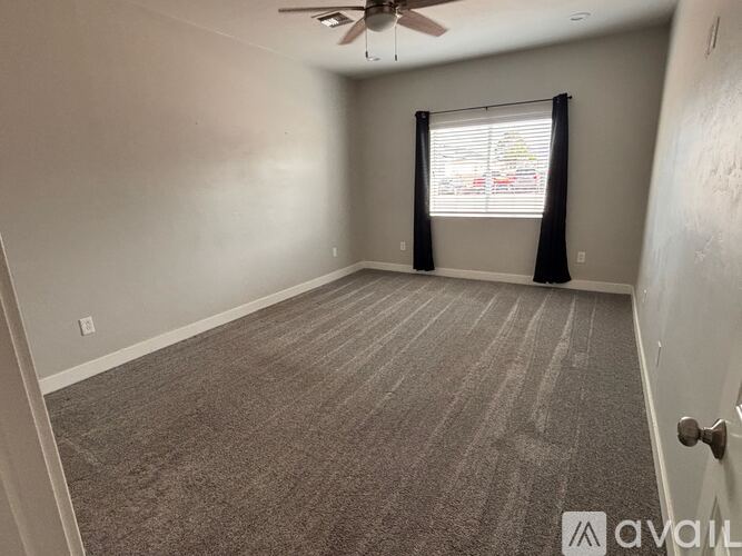 A room with a car visible through the window.