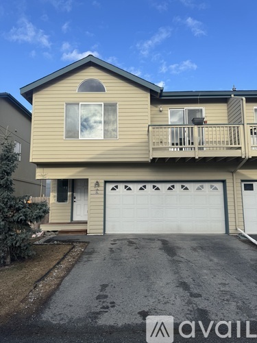 A two-story house with a garage is for sale.